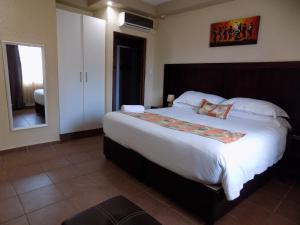 ein Schlafzimmer mit einem großen Bett in einem Zimmer in der Unterkunft Margate Beach Lodge in Margate