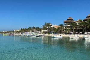 a group of boats are docked on a beach at blue angel 3 in Playa del Carmen