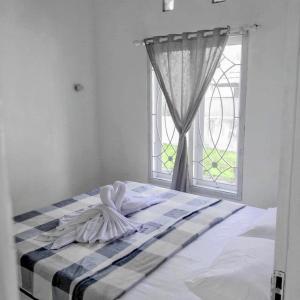 a bed in a room with a window at Pigeon House Nusa Dua in Nusa Dua +14 photos
