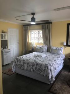 a bedroom with a bed and a window at Dawn's Place in Hermanus