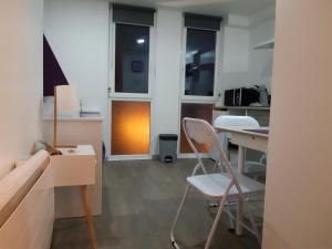a room with two chairs and a table and some windows at Studio-Cosy 2 vue port à deux pas de Nausicaa in Boulogne-sur-Mer