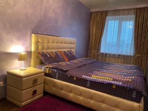 a bedroom with a bed and a window at Kharkiv Center Apartment on Hoholya Str, Poetry square in Kharkiv