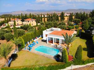 an aerial view of a house with a swimming pool at Chriseleni Latchi Villas in Polis Chrysochous
