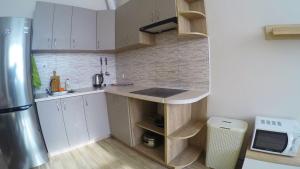 a small kitchen with white cabinets and a counter top at Просторная квартира в Одессе in Odesa