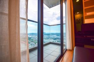 a room with a large window with a view of a city at Landmark Residence 1 SOHO 2pax by A's Homestay 8 in Kajang
