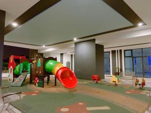 a childrens play area with a slide in a room at Landmark Residence 1 SOHO 2pax by A's Homestay 8 in Kajang