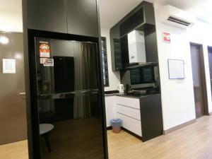 a kitchen with a black and white kitchen at Landmark Residence 1 SOHO 2pax by A's Homestay 8 in Kajang