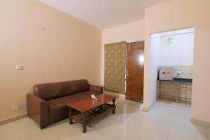 sala de estar con sofá y mesa de centro en Atithi Suites - An AHG Hotel, en Greater Noida