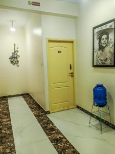 a room with a yellow door and a stool at Sports Icon Suites in Yelahanka