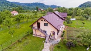 an aerial view of a house with a fence at Pensiunea Casa Maria in Corbeni