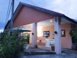 a house with a red roof and a patio at Les Fleurs House in Khao Lak