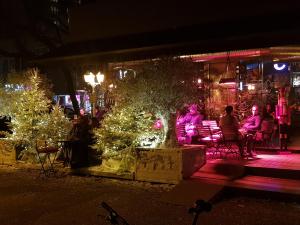 a group of people sitting on a bench next to christmas trees at MarSim Lux apartman Zagreb in Zagreb