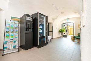 a room with two large refrigerators in a building at Velden24 - create your own stay in Velden am Wörthersee