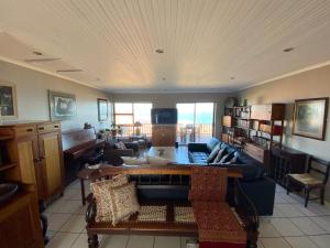 a living room with a couch and a table at Relax & Recharge in Boggomsbaai