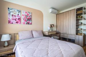 a bedroom with a large bed and a desk at Maison de Rose in Quy Nhon