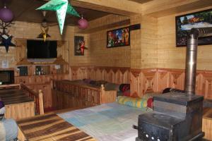 a room with a room with wooden walls at Third Eye Tosh in Tosh