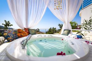 a bath tub sitting on top of a patio at Highclere Hotel and Spa in Faralya