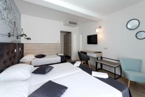 Кровать или кровати в номере Hotel Perla