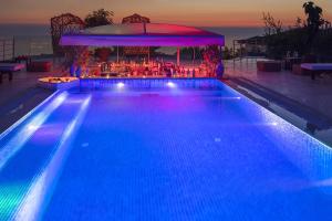 a swimming pool with a gazebo and a bar at Highclere Hotel and Spa in Faralya