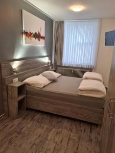 sypialnia z dużym łóżkiem i oknem w obiekcie Pension Zwei A w mieście Leverkusen