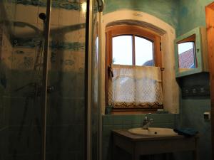 a bathroom with a sink and a shower at Pod tulipanem nad jeziorem in Zawady Oleckie