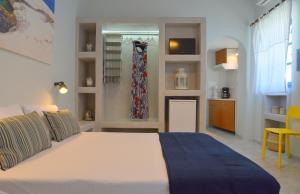A bed or beds in a room at Tsakonas Plakes Studios