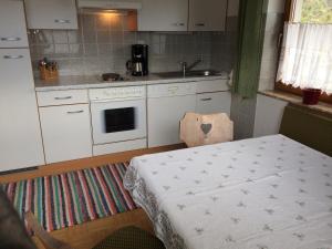 a small kitchen with a table and a stove at Haus Eiter in Nassereith