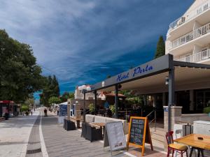 a building with a restaurant on a street at Hotel Perla in Dubrovnik