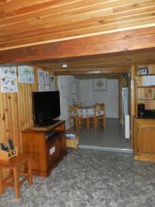 ein Wohnzimmer mit Flachbildfernseher und Tisch in der Unterkunft L'Epicéa in Saint-Jean-dʼArves + 37 Fotos