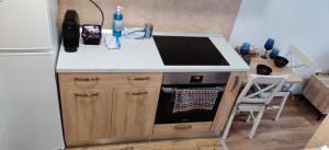 a kitchen with a stove top oven next to a refrigerator at Marius Studio in Braşov