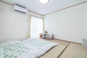 Postel nebo postele na pokoji v ubytování Travel Palace Miyuki