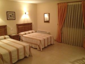 Postel nebo postele na pokoji v ubytování Hotel Las Fuentes