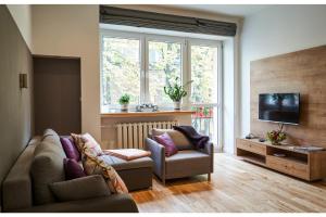 a living room with two couches and a television at Kredytowa Warsaw Apartment in Warsaw