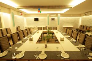 a large conference room with a long table and chairs at Hotel Premiere Villa in Varanasi