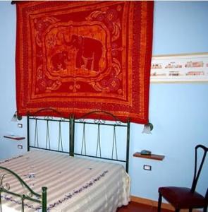 - une chambre avec un lit et un tapis rouge au-dessus dans l'établissement B&B Sudest, à Acquarica del Capo