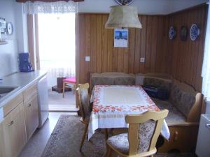 a kitchen with a table and a couch and a table and chairs at Ferien-bei-Seifert in Dresden