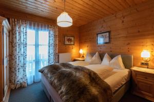 a bedroom with a bed in a wooden room at Appartments Jandlbauer in Wagrain