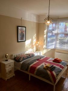a bedroom with a bed and a window at Lavender Apartment in Leicester