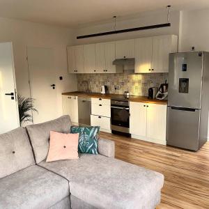 a living room with a couch and a kitchen at Countryside Retreat in Janowice Wielkie +9 photos