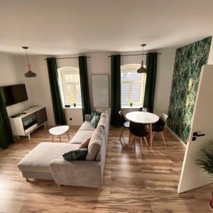 a living room with a couch and a table at Countryside Retreat in Janowice Wielkie