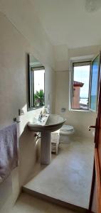a bathroom with a sink and a toilet at B&B del Porto in Bosa Marina