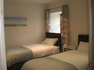 A bed or beds in a room at The Courtyard 