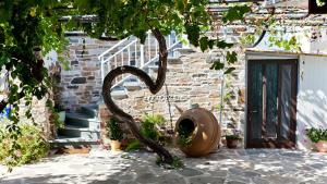 a sculpture of a snake next to a building at Anastasia Rooms in Skala Potamias