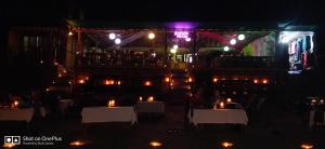 a restaurant at night with candles on tables at Rococo Pelton beach huts Palolem Beach goa in Palolem