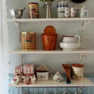 a shelf filled with lots of dishes and cups at Foggy Island B&B in Kaskö