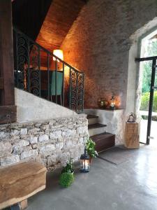
a room with a stone wall and a stone staircase at La Ferme Des Impressionnistes in Gasny
