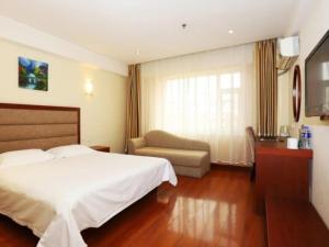 a hotel room with a bed and a chair at GreenTree Inn Jilin Changchun Haoyue Road Express Hotel in Changchun