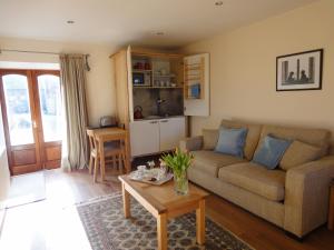 a living room with a couch and a table at The Courtyard in Errol