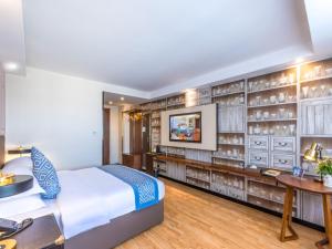 Postel nebo postele na pokoji v ubytování Gme Fuyang Guangming South Road Hotel