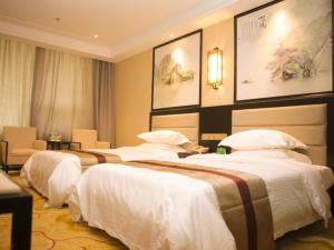 Tempat tidur dalam kamar di GreenTree Alliance Texas Ningjin County Zhengyang Road Debai Plaza Hotel